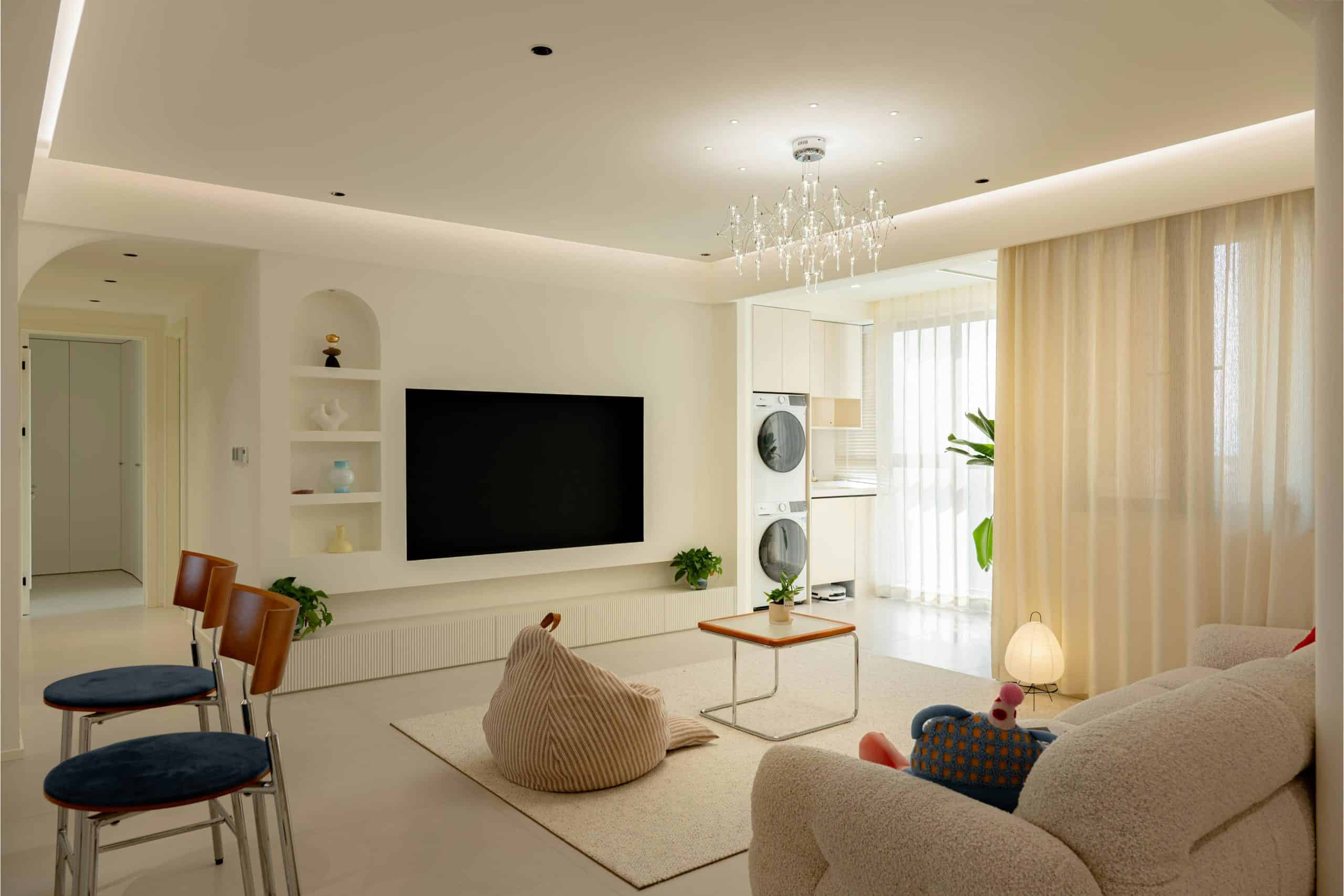 Bright modern living room with minimalist decor, open layout, and natural sunlight, perfect for sharing referrals.